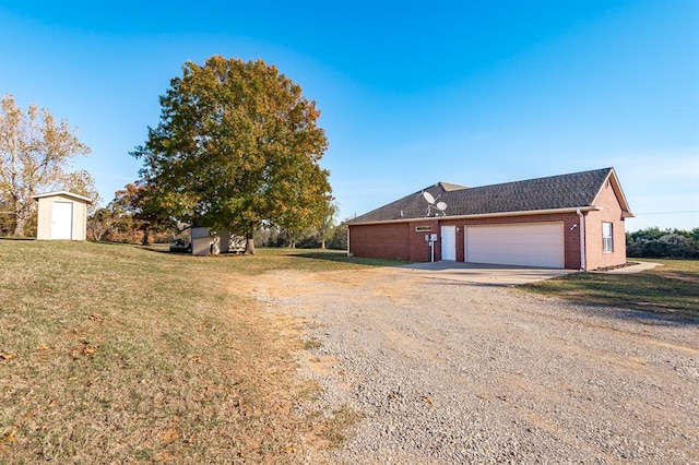 exterior space featuring a garage, a shed, and a front yard