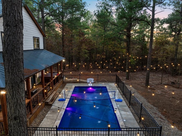 pool at dusk with a patio