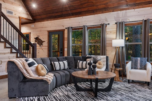 living room with vaulted ceiling and wood walls