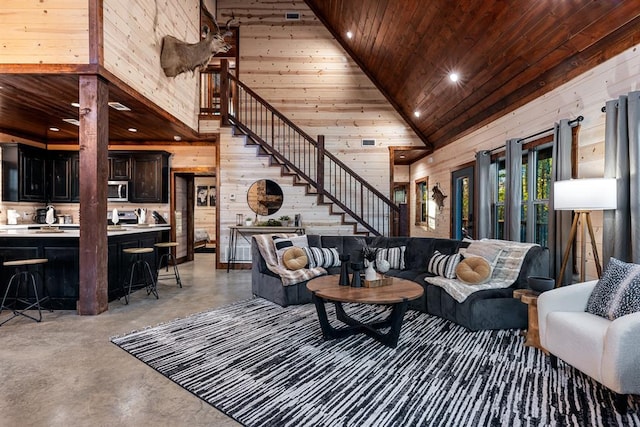 living room with wooden walls, high vaulted ceiling, and wooden ceiling