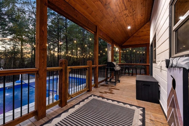 wooden deck with a grill and a covered pool