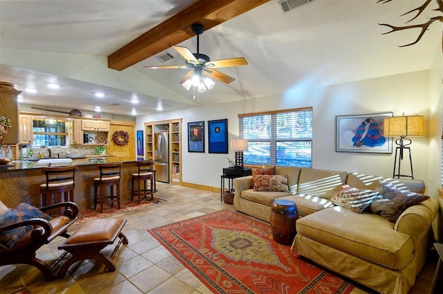 living room featuring vaulted ceiling with beams, ceiling fan, sink, and light tile patterned flooring