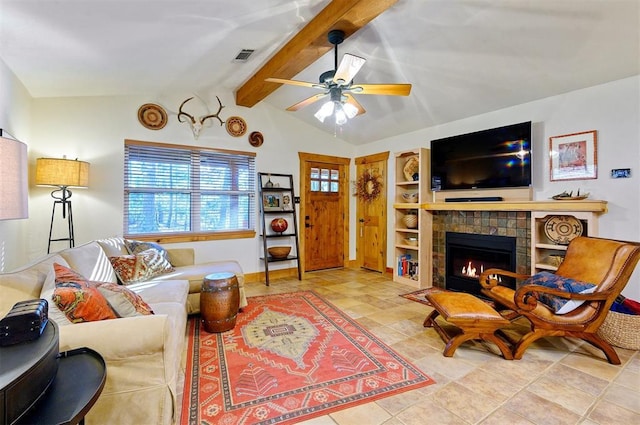 living room with a tiled fireplace, ceiling fan, and lofted ceiling with beams