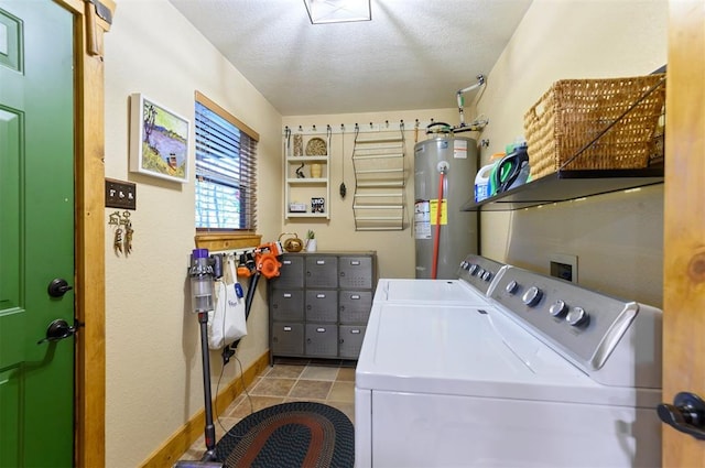 clothes washing area featuring independent washer and dryer, electric water heater, and a textured ceiling