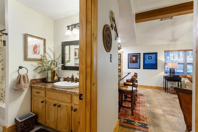 bathroom with tile patterned floors and vanity