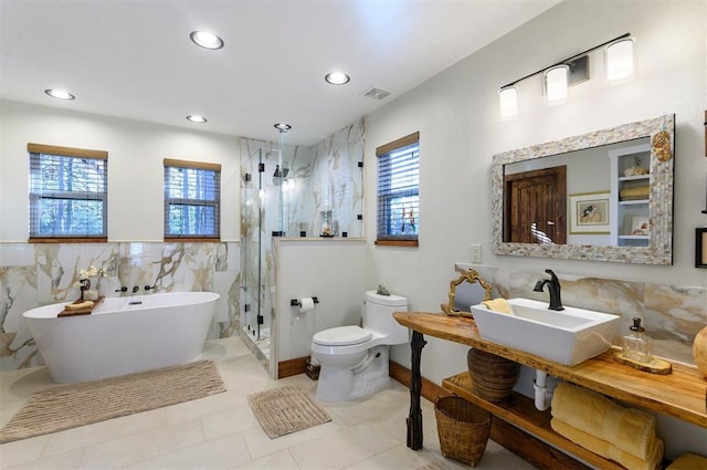 full bathroom with plus walk in shower, toilet, plenty of natural light, and sink