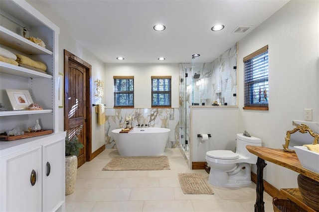 bathroom with tile patterned flooring, toilet, tile walls, and independent shower and bath