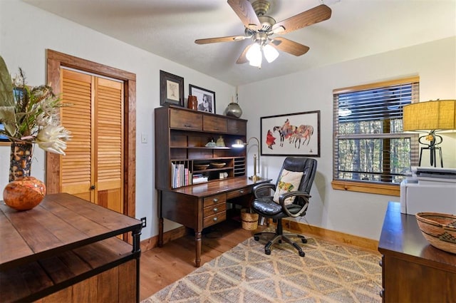 office featuring light wood-type flooring and ceiling fan