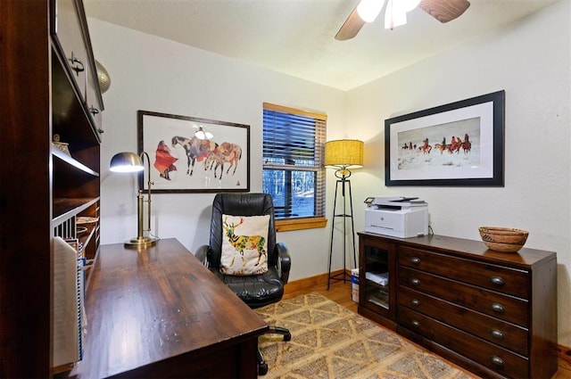 office area with light wood-type flooring and ceiling fan