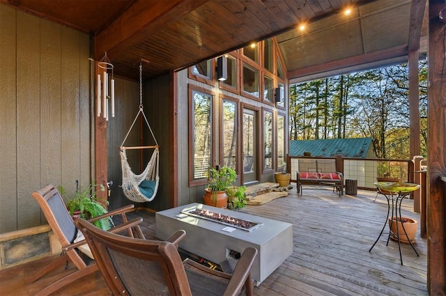 sunroom / solarium featuring wood ceiling