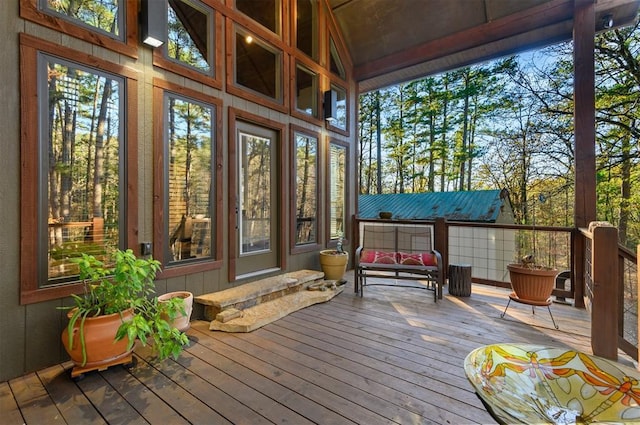 sunroom / solarium featuring vaulted ceiling