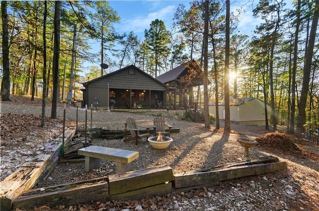 back of property with a fire pit