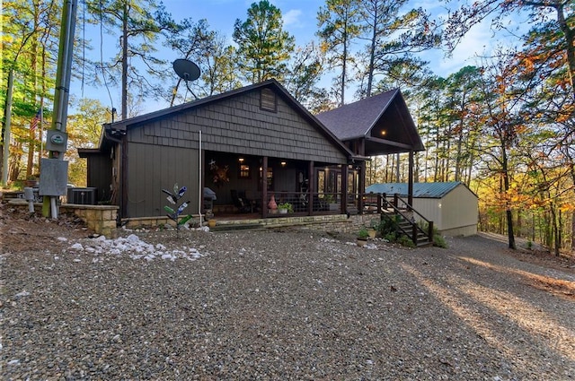 view of front facade featuring cooling unit and an outdoor structure