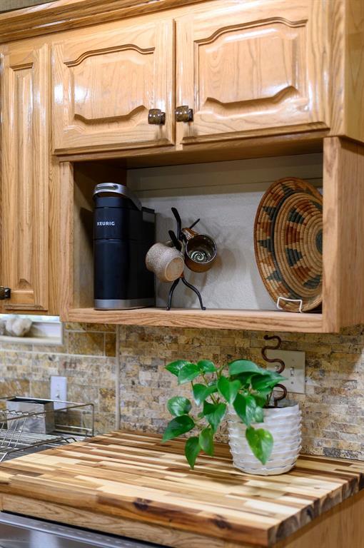 details featuring decorative backsplash and butcher block counters