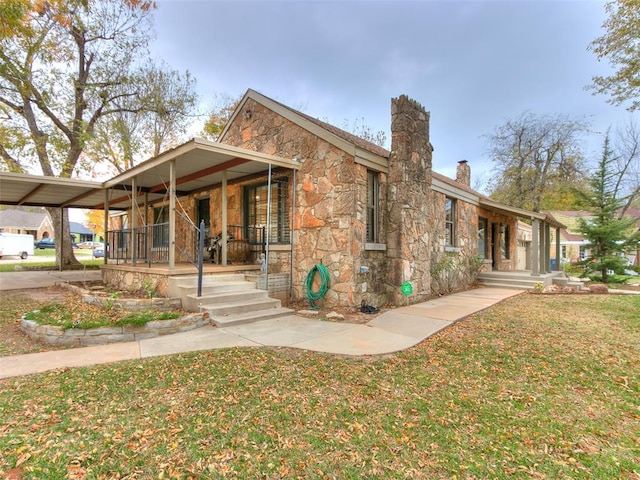 exterior space with covered porch and a front lawn