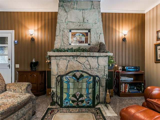 living room with light carpet, a fireplace, wooden walls, and crown molding