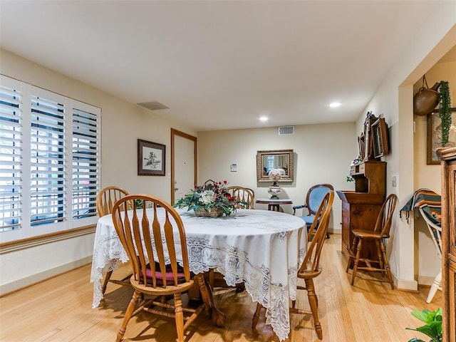 dining area with light hardwood / wood-style floors