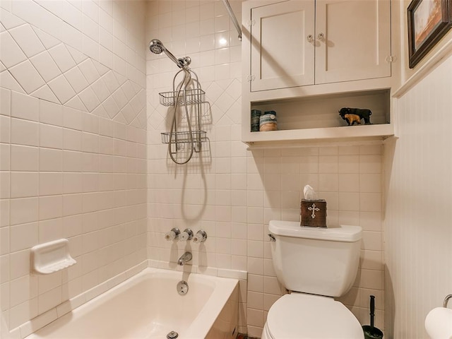 bathroom featuring toilet, tiled shower / bath, and tile walls