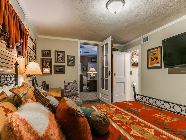 bedroom with a textured ceiling, ornamental molding, and carpet floors