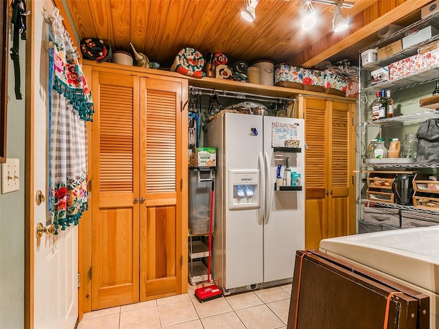 kitchen featuring light tile patterned flooring, wood ceiling, and white fridge with ice dispenser