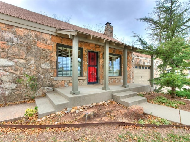 property entrance with a porch and a garage