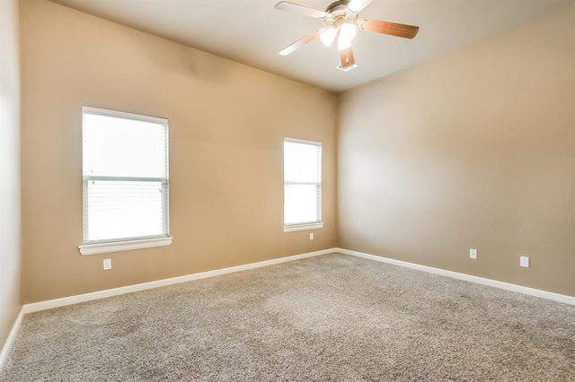 carpeted spare room featuring ceiling fan