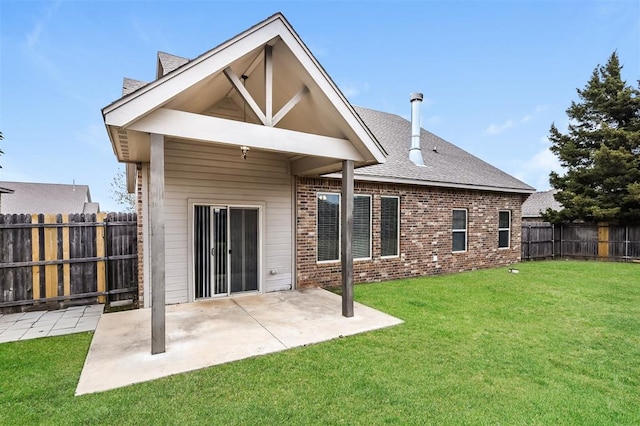 rear view of property with a patio and a lawn