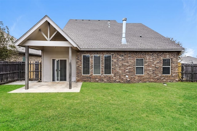 rear view of property with a patio and a lawn