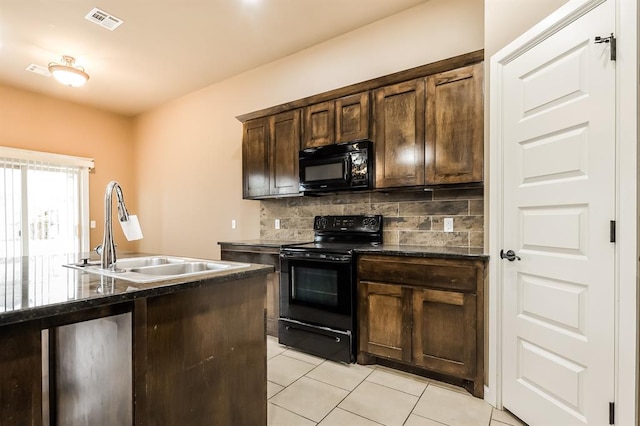 kitchen with dark brown cabinetry, sink, tasteful backsplash, light tile patterned floors, and black appliances