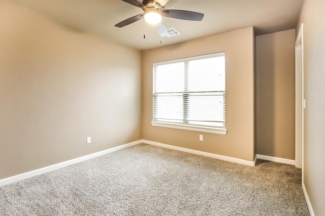 spare room featuring carpet flooring and ceiling fan