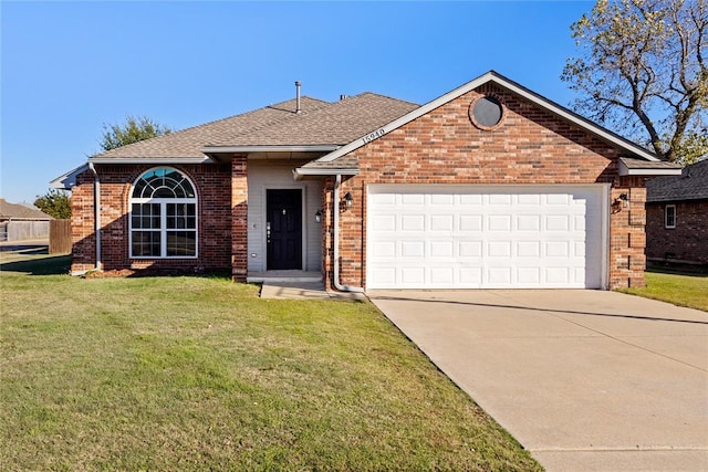 view of front of property with a garage and a front lawn