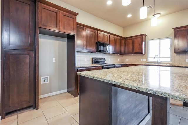 kitchen featuring light stone countertops, sink, hanging light fixtures, tasteful backsplash, and black appliances