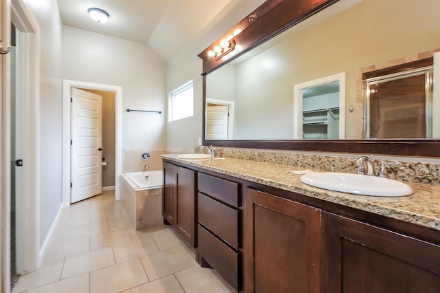 bathroom featuring tile patterned floors, vanity, separate shower and tub, and vaulted ceiling