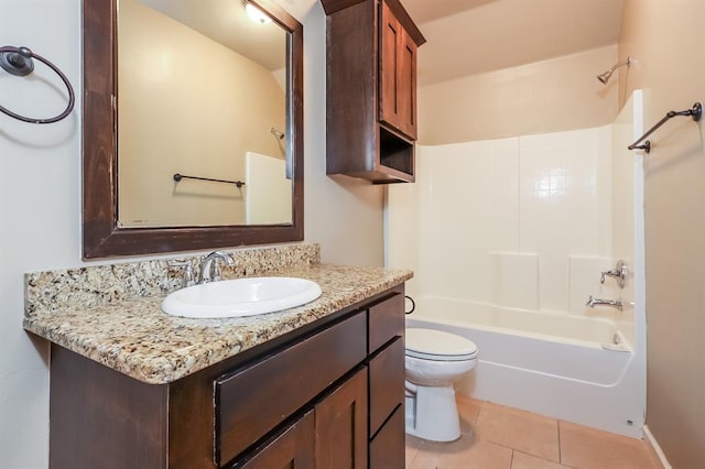 full bathroom with toilet, vanity,  shower combination, and tile patterned floors