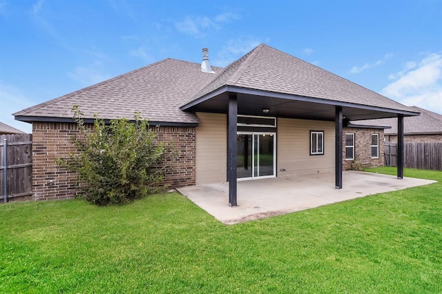 rear view of property featuring a yard and a patio