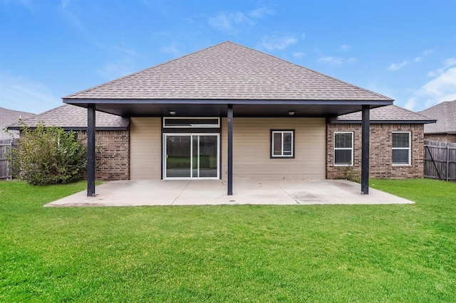 rear view of property featuring a yard and a patio area