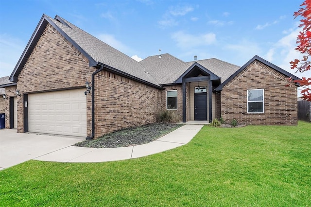 view of front of home with a garage and a front lawn