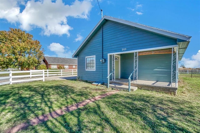 back of house featuring a yard