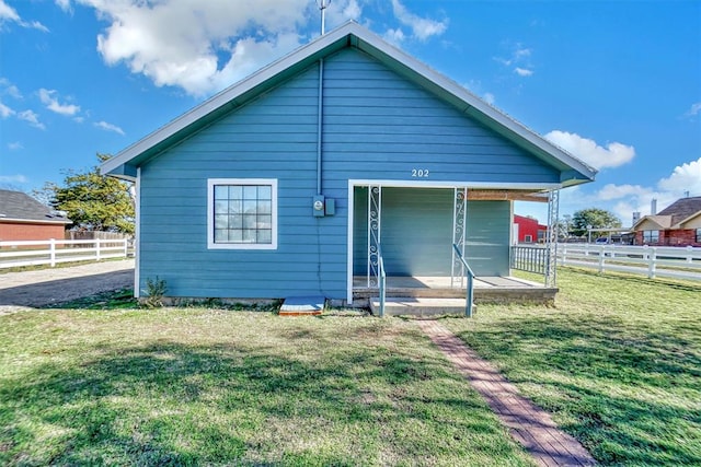 back of house with a yard