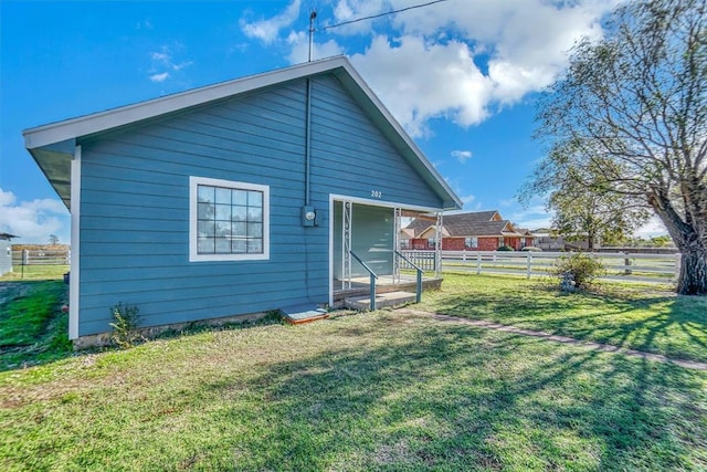 rear view of house with a yard