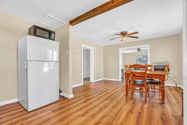 dining room featuring beamed ceiling, ceiling fan, and light hardwood / wood-style flooring