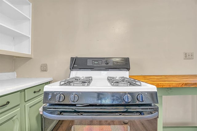 interior details featuring white range with gas cooktop and green cabinets