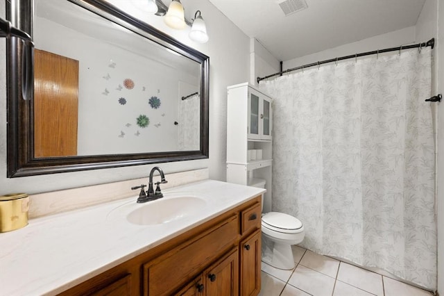 bathroom featuring tile patterned flooring, vanity, and toilet