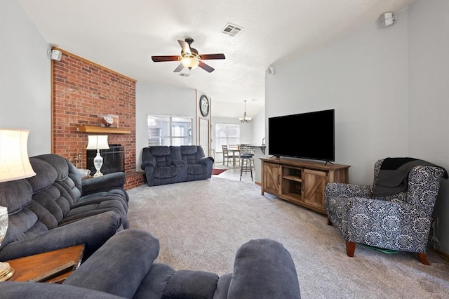 living room with light colored carpet, a fireplace, and ceiling fan with notable chandelier