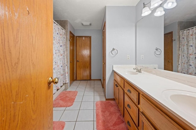 bathroom with a shower with shower curtain, vanity, and tile patterned flooring