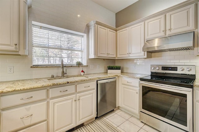 kitchen featuring decorative backsplash, light tile patterned floors, sink, and appliances with stainless steel finishes