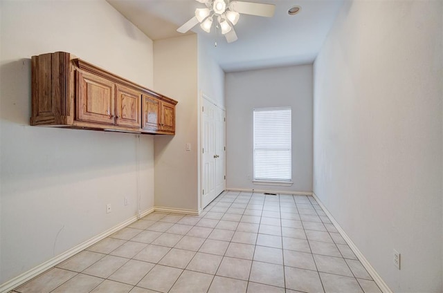 washroom featuring ceiling fan and light tile patterned floors