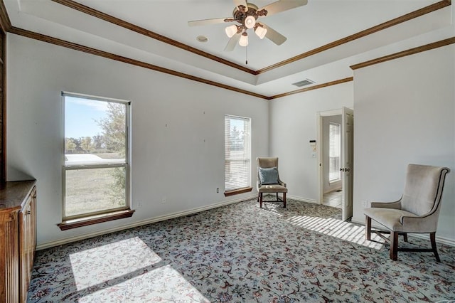 living area featuring ceiling fan, light colored carpet, and ornamental molding