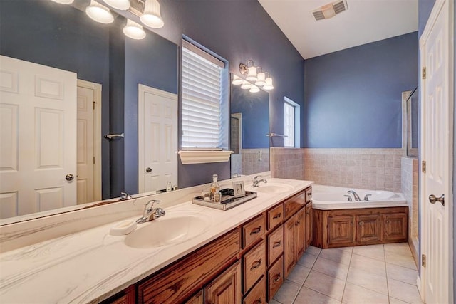 bathroom with vanity, tile patterned flooring, and a bathtub