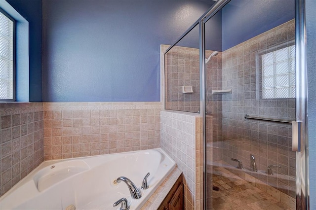 bathroom with separate shower and tub